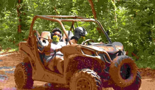 couple in mud buggy and atv in jamaica
