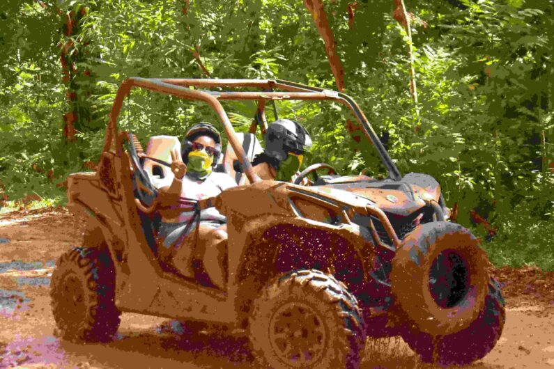 couple in mud buggy and atv in jamaica